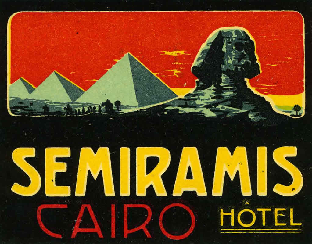 View of Sphinx with pyramids in background; red, blue, yellow, black