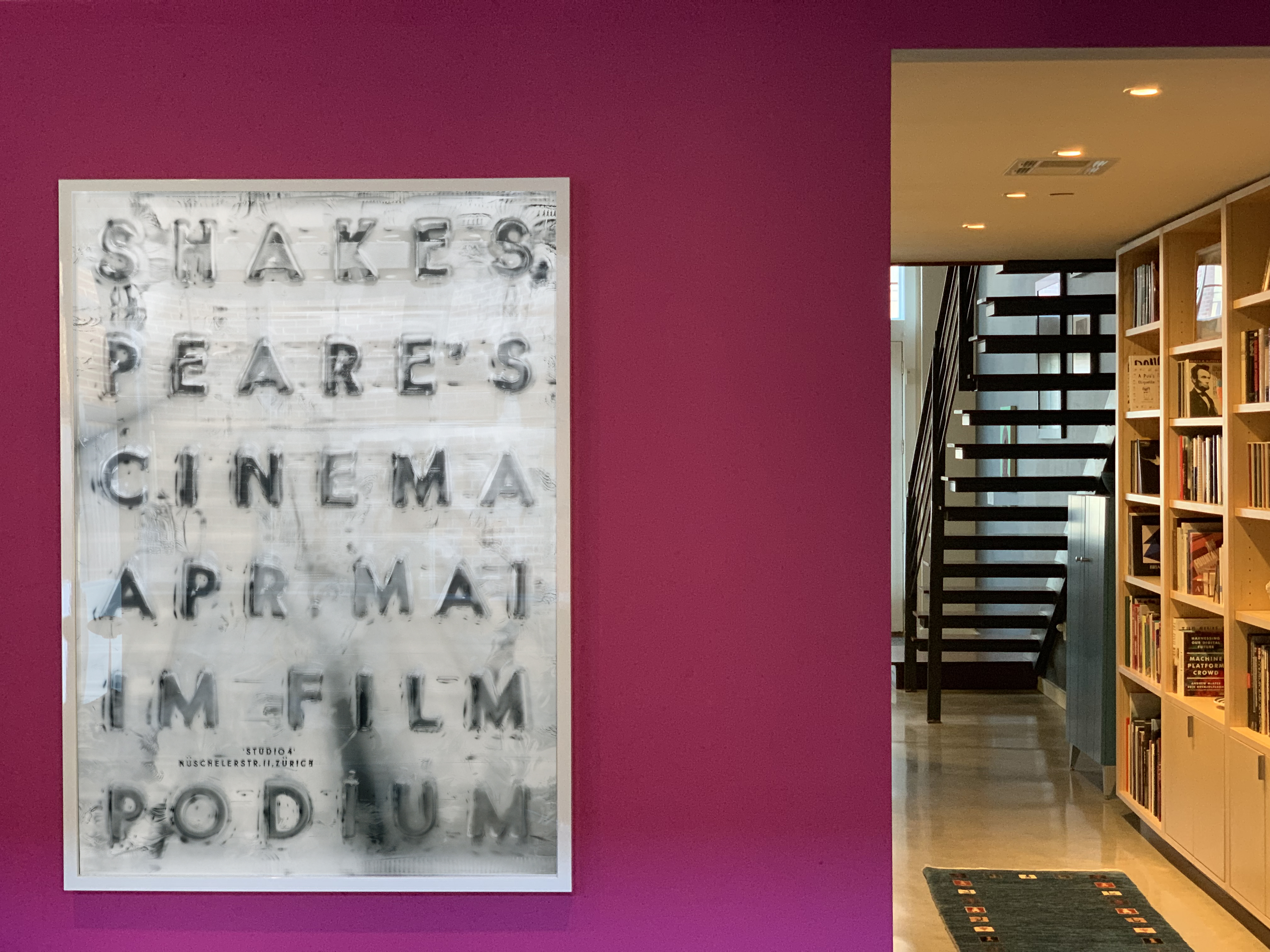 hallway with accent wall and Shakespeare Filmpodium poster; pink, white, black