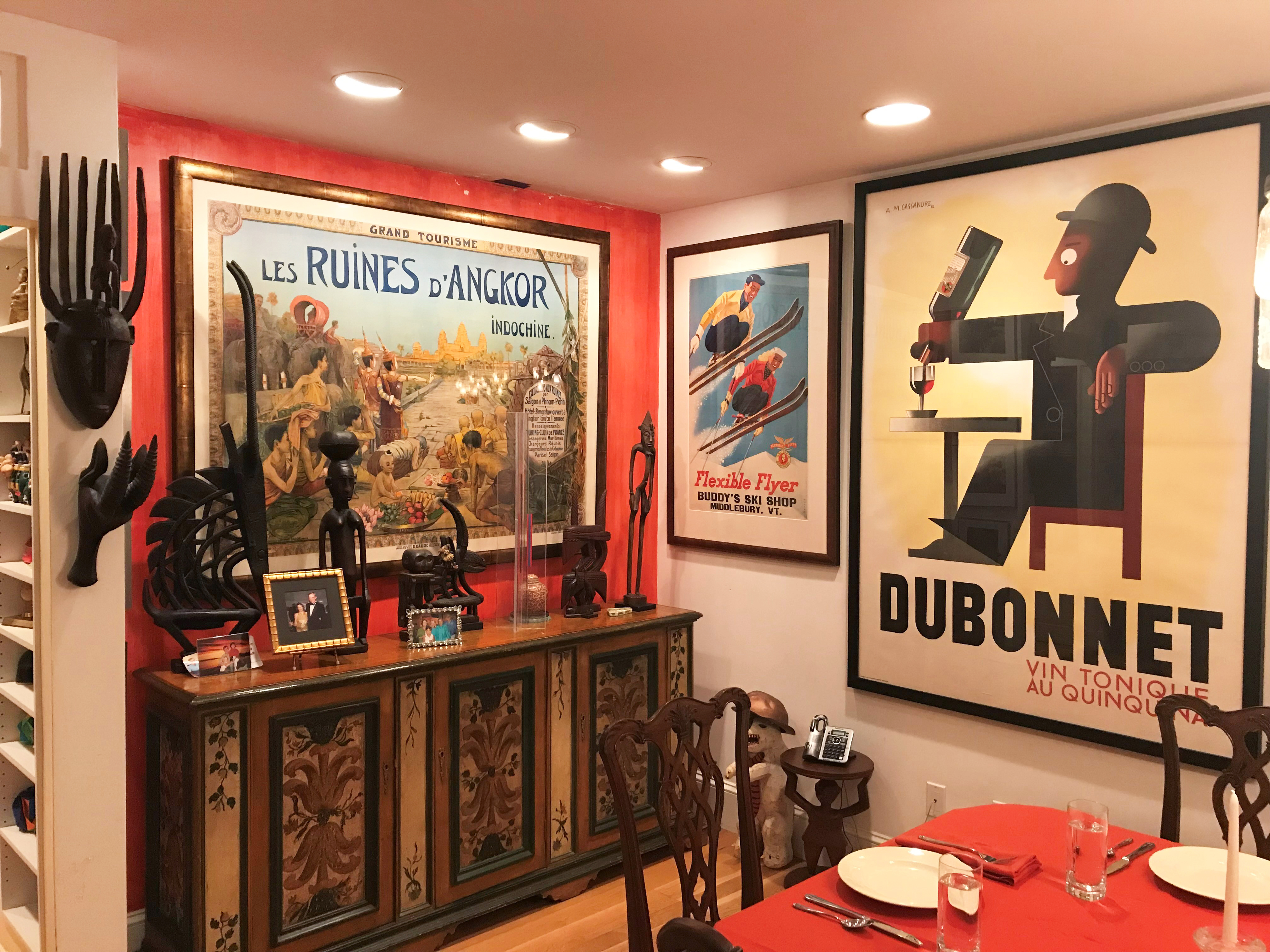 posters on a wall with anthropological artifacts nearby