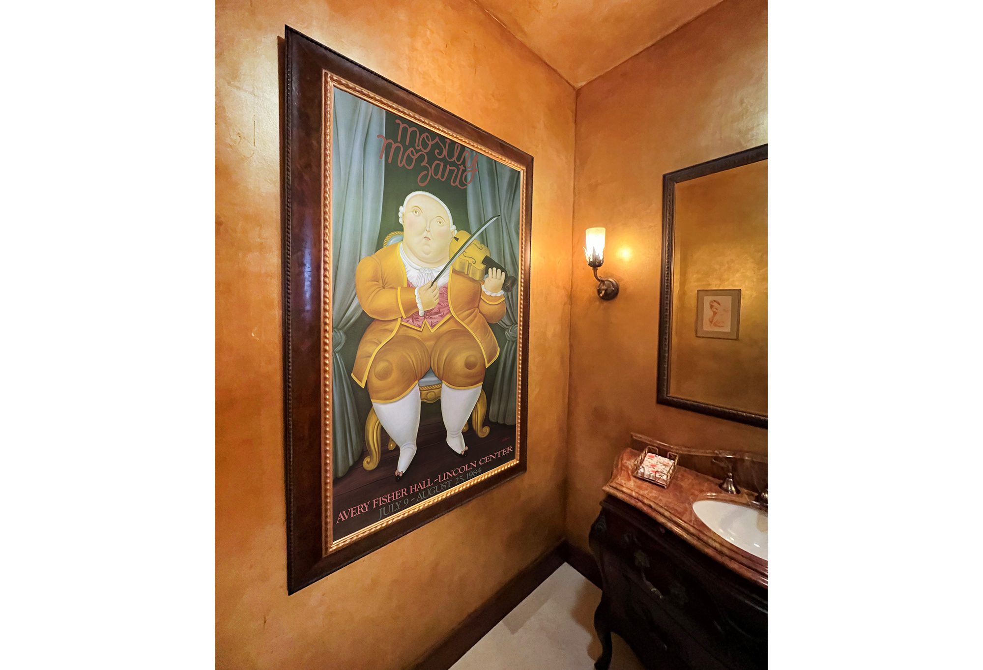 poster of violin player framed in bathroom